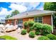 Brick home exterior featuring a cozy patio and vibrant green shrubs in the landscaped backyard at 109 National Way, Carrollton, GA 30116
