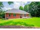 Expansive backyard features lush green grass, a patio set, and privacy provided by mature trees at 109 National Way, Carrollton, GA 30116