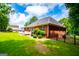 Large backyard features lush lawn with a stone patio, perfect for outdoor enjoyment and entertainment at 109 National Way, Carrollton, GA 30116