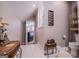 Hallway leading to cozy bathroom featuring a pedestal sink, glass-enclosed shower, and decorative accents at 109 National Way, Carrollton, GA 30116