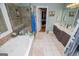 Bathroom featuring a bathtub, walk-in shower, and double vanity at 109 National Way, Carrollton, GA 30116