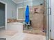 Bathroom featuring a soaking tub, glass-enclosed shower, and tiled walls at 109 National Way, Carrollton, GA 30116