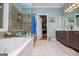 Bathroom showcasing a walk-in shower, a tub, double sinks, and ample space at 109 National Way, Carrollton, GA 30116