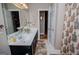 Bathroom featuring double sinks, tile floors and dark wood cabinets at 109 National Way, Carrollton, GA 30116