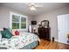 Cozy bedroom featuring wood floors, ceiling fan, and a sunny window with plantation shutters at 109 National Way, Carrollton, GA 30116