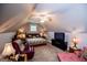 Attic bedroom features vaulted ceilings, ceiling fan, and a sitting area at 109 National Way, Carrollton, GA 30116