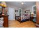 Cozy bedroom featuring wood floors, ceiling fan, and a furniture at 109 National Way, Carrollton, GA 30116