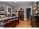 Cozy bedroom featuring wood floors, ceiling fan, and a furniture at 109 National Way, Carrollton, GA 30116
