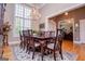 Formal dining room with a large window, hardwood floors, and traditional furnishings at 109 National Way, Carrollton, GA 30116