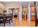View of a dining room and living room with hardwood floors and decorative lighting at 109 National Way, Carrollton, GA 30116