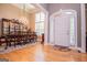 Elegant entryway featuring hardwood floors, chandelier, dining set and an arched door at 109 National Way, Carrollton, GA 30116