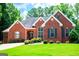 Inviting brick home boasting a neatly manicured lawn, mature trees, and a well-maintained exterior at 109 National Way, Carrollton, GA 30116