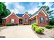 Beautiful brick home showcasing a wide driveway, two-car garage, neat landscaping, and inviting facade at 109 National Way, Carrollton, GA 30116