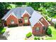 Well maintained brick home with a lush green lawn and mature trees, offering a private and serene front yard setting at 109 National Way, Carrollton, GA 30116