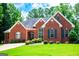 Charming brick home with a manicured lawn and mature trees offering classic curb appeal at 109 National Way, Carrollton, GA 30116