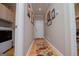 Inviting hallway with wood floors and decorative rugs leading to laundry and other rooms at 109 National Way, Carrollton, GA 30116