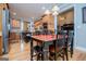View of a kitchen and a wooden dining table with seating for four guests, with wood-look flooring at 109 National Way, Carrollton, GA 30116