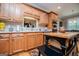 Kitchen with stainless steel appliances and wooden cabinets and a dark kitchen island at 109 National Way, Carrollton, GA 30116