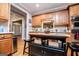Kitchen showing wood cabinets, breakfast bar, and stainless steel appliances at 109 National Way, Carrollton, GA 30116