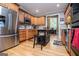 Well-lit kitchen with an island, stainless steel appliances and hardwood floors at 109 National Way, Carrollton, GA 30116