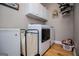 Well-equipped laundry room with white cabinets, modern washer/dryer, and ample storage space at 109 National Way, Carrollton, GA 30116