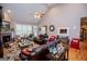 Spacious living room featuring vaulted ceilings, hardwood floors, a ceiling fan, and a cozy fireplace at 109 National Way, Carrollton, GA 30116
