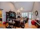 Open-concept living room with high ceilings, hardwood floors, a fireplace, and comfortable seating at 109 National Way, Carrollton, GA 30116