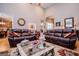 Bright living room with high ceilings, hardwood floors, neutral colors, and comfortable leather sofas at 109 National Way, Carrollton, GA 30116