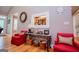 Cozy sitting area in the living room with hardwood floors, red accent chairs, and decorative accents at 109 National Way, Carrollton, GA 30116