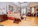 Well-lit main bedroom featuring a four-poster bed, tray ceiling, and hardwood floors at 109 National Way, Carrollton, GA 30116