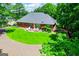 Brick home with a lush green lawn and patio, surrounded by mature trees, offering a private and serene backyard setting at 109 National Way, Carrollton, GA 30116