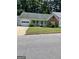 Charming single-story home featuring a well-maintained lawn and attached garage at 207 Oak N Cir, Stockbridge, GA 30281