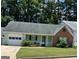 Charming one-story home featuring a well-maintained lawn, attached garage, and inviting front porch at 207 Oak N Cir, Stockbridge, GA 30281