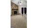 Cozy living room features a stone fireplace and ceiling fan with french doors to the exterior at 207 Oak N Cir, Stockbridge, GA 30281