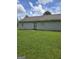 A well-maintained backyard featuring lush green grass, a rear entrance, and a clean exterior with siding at 2985 Garnet Way, South Fulton, GA 30349