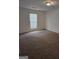 Cozy bedroom with a window for natural light, neutral walls, and plush carpeting, creating a comfortable space at 2985 Garnet Way, South Fulton, GA 30349