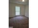 Bright bedroom with a large window, neutral walls, and comfortable carpeting, perfect for relaxation at 2985 Garnet Way, South Fulton, GA 30349