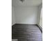 Bright, empty bedroom with natural light, and wood-look flooring at 2985 Garnet Way, South Fulton, GA 30349