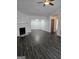 Spacious living room with a fireplace, ceiling fan and dark wood-look floors at 2985 Garnet Way, South Fulton, GA 30349