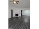 Inviting living room with fireplace, ceiling fan, and seamless flow to dining area at 2985 Garnet Way, South Fulton, GA 30349