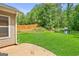 Spacious, grassy backyard with wood fence, patio, and playset at 107 Meadowbrook Ln, Grantville, GA 30220