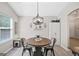 Cozy dining area featuring a round wooden table and stylish chandelier, perfect for intimate meals at 107 Meadowbrook Ln, Grantville, GA 30220