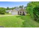 Well-maintained home featuring a lush green lawn and mature trees at 107 Meadowbrook Ln, Grantville, GA 30220