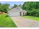 Inviting home showcasing a well-kept yard and a spacious driveway at 107 Meadowbrook Ln, Grantville, GA 30220
