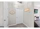 Neutral hallway with a laundry room sign and views into the living room at 107 Meadowbrook Ln, Grantville, GA 30220