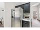 Kitchen with stainless steel refrigerator complemented by adjacent black cabinets and countertops at 107 Meadowbrook Ln, Grantville, GA 30220