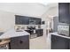Modern kitchen with dark cabinetry, stainless steel appliances, and stylish backsplash at 107 Meadowbrook Ln, Grantville, GA 30220