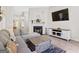 Spacious living room with a fireplace, TV, and comfortable seating, ideal for relaxation and entertainment at 107 Meadowbrook Ln, Grantville, GA 30220