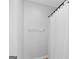 Bright shower with white shower curtain and chrome fixtures at 107 Meadowbrook Ln, Grantville, GA 30220