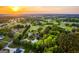 Beautiful aerial view of property, showcasing surrounding landscape, community and picturesque sunset at 3700 Tom Brewer Rd, Loganville, GA 30052
